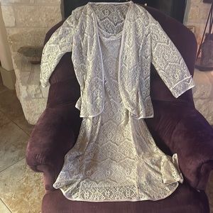 Elegant dress. Shimmering taupe color Fluted hem and jacket Pearl details.